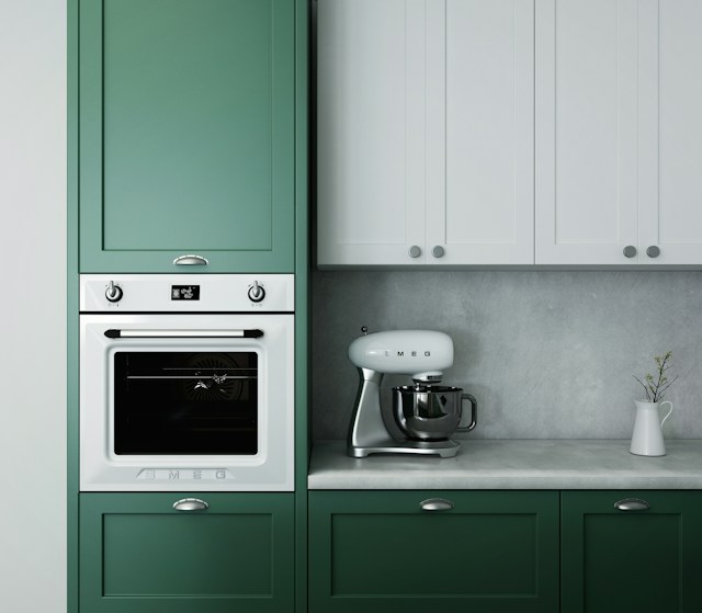 A kitchen with an oven and a stand mixer.