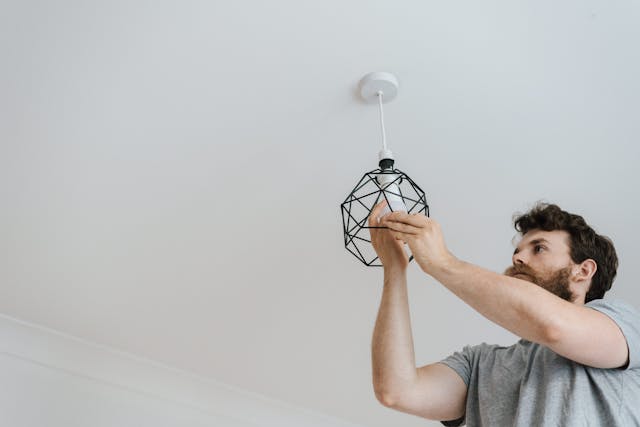 A person changing a lightbulb.