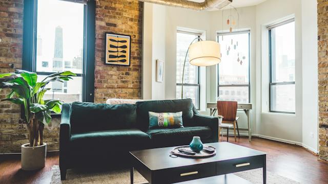 A furnished living room with brick walls.